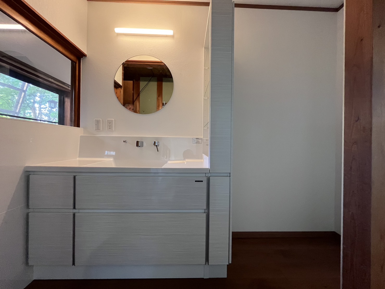 浴室に続き洗面化粧台もタカラスタンダードを採用！ 『ファミーユ』はホーローパネルが使用されているので汚れも心配ありません！ 丸い鏡と、左のガラスはこれまでの印象を残すために、既存を再利用しています。